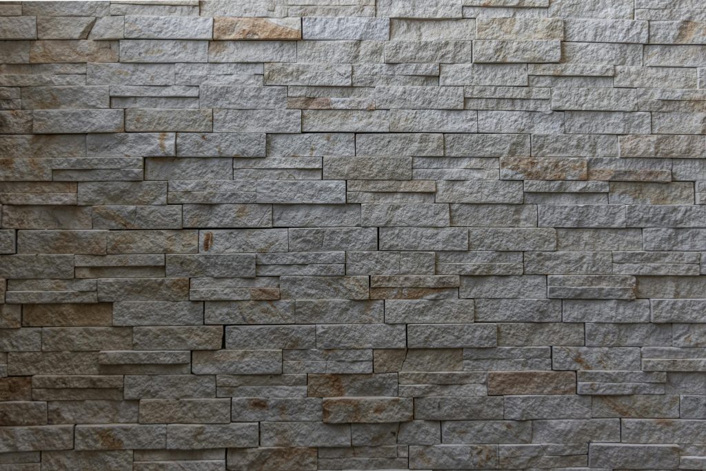 High-resolution image of a rustic stone wall perfect for backgrounds, emphasizing texture and design.